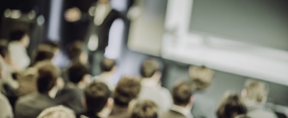 Large Group of People Listening to a Presentation