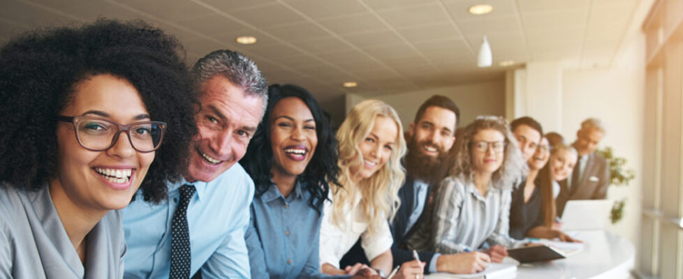 Cheerful multiracial colleagues looking at camera in office